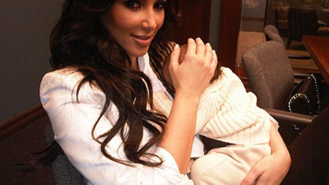 Kim Kardashian holding her nephew Mason. 