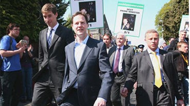 Britain's Liberal Democrat leader Nick Clegg, center, leaves the Community Church in Bristol, England after a general election campaign visit to the Infant Mother and Pre School group at the church Thursday April 22, 2010. Britain's second televised elect 