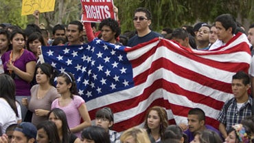 Demonstrators hold a U.S. flag at a protest at the Arizona state Capitol in Phoenix on Thursday, April 22, 2010 against the controversial illegal immigration bill SB1070. 