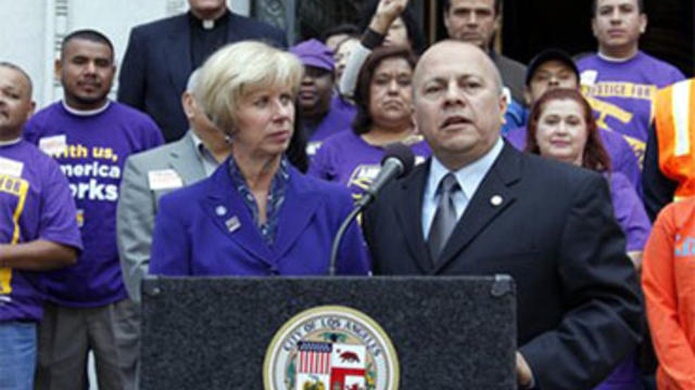 Joined by supporters, Los Angeles city council members Janice Hahn and Ed Reyes talk with reporters after the Los Angeles City Council voted 13-1 to approve a resolution to seek sanctions that might include canceling contracts with Arizona, after that sta 