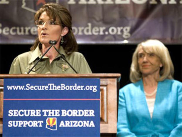 Former Alaska Governor Sarah Palin, left, speaks as Arizona Gov. Jan Brewer looks on at a news conference about border security at the JW Marriott Desert Ridge in Phoenix on Saturday, May 15, 2010. Brewer and Palin blamed President Barack Obama for the st 