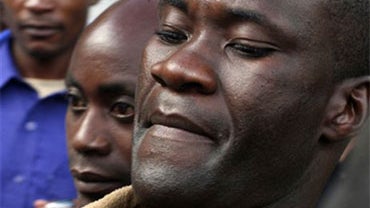 In this photo taken Thursday May, 20, 2010 file photo, Tiwonge Chimbalanga, foreground, and Steven Monjeza, left back, are led from court in Blantyre, Malawi, after a judge sentenced the couple to the maximum 14 years in prison for unnatural acts and gros 
