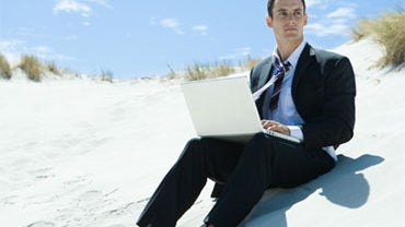 On the beach, but not away from work. 