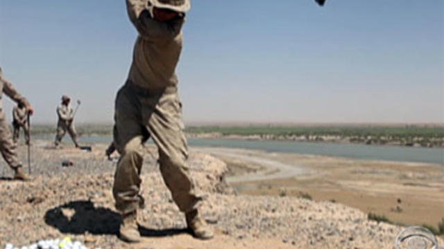 U.S. troops teeing off at a base in Afghanistan.  