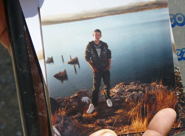 An unidentified relative shows a photo of Sergio Adrian Hernandez Huereka, 15, to the press outside his mother's home in the northern border city of Ciudad Juarez, Mexico, June 8, 2010. 