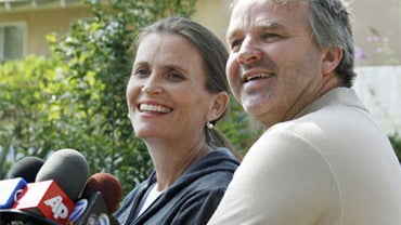 Laurence Sunderland puts his hand on the belly of his wife, Marianne, who is expecting, as they talk to reporters about their daughter Abby Sunderland, would-be solo round-the-world sailor, at their home in Thousand Oaks, Calif., Saturday morning, June 12 