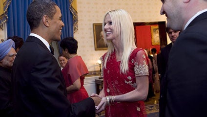 President Obama shakes hands with Michaele Salahi as her husband Tareq Salahi looks on in a receiving line for the president's first state dinner Tuesday, Nov. 24, 2009. Both the White House and the Secret Service said the couple wasn't invited to the din 