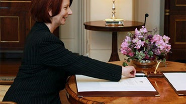 n this photo provided by Government House, Australian Prime Minister Julia Gillard smiles as she is sworn in by the Governor General at Government House in Canberra, Australia, Thursday, June 24, 2010. 