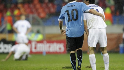 Uruguay's Diego Forlan, left, and South Korea's Cho Yong-hyung, right, walk off the pitch following the World Cup round of 16 soccer match between Uruguay and South Korea at Nelson Mandela Bay Stadium in Port Elizabeth, South Africa, Saturday, June 26, 20 