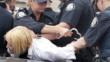 A woman is arrested outside Toronto's detention center during the G20 summit Sunday, June 27, 2010 in Toronto. 