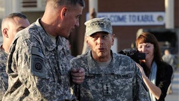 In this July 2, 2010 photo released by the U.S. Air Force, newly appointed International Security Assistance Forces Commander, Gen. David Petraeus, center right, greets Lt. Gen. David Rodriguez upon his arrival in Kabul, Afghanistan to take command of U.S 