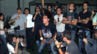 An Afghan man dances and waves his head as the indie rock band Kabul Dreams performs during a party in Kabul, Afghanistan, June 18, 2010. 