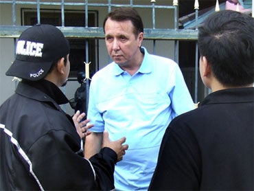 Mikhail Vasillievich Pletnev, Center, is Questioned by a Thai Police Officer (AP Photo) 