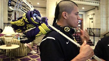 Jeremy Thompson, left, a member of the Iroquois Nationals Lacrosse team, chats with his father Jerome Thompson, Sr., a team coach, while waiting for travel visas in New York, Monday, July 12, 2010. The 23 players on the Iroquois Indian lacrosse team canno 