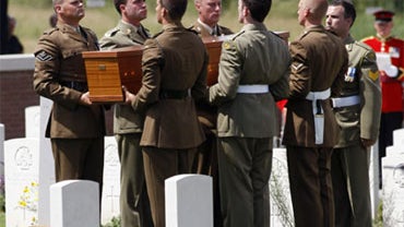 British and Australian soldiers carry the coffin of an Australian unknown soldier during a ceremony at the British Australian cemetery of Fromelles, Northern France, Monday, July 19, 2010. 