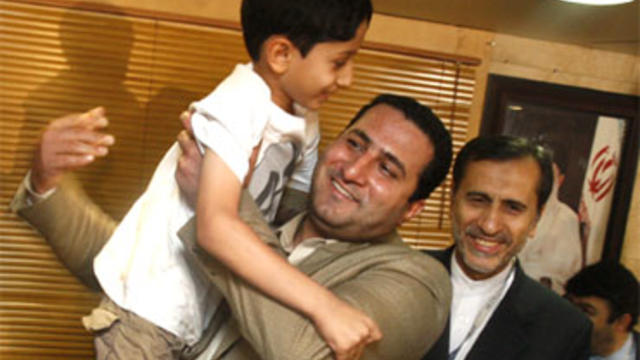 Shahram Amiri, center, an Iranian nuclear scientist who disappeared a year ago, holds his 7-year-old son Amir Hossein after arriving at the Imam Khomeini airport just outside Tehran, Iran, July 15, 2010. He has reportedly provided "valuable" information a 