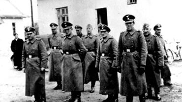 This photo made available by Yad Vashem Photo Archive in Jerusalem shows Nazi guards at Belzec death camp in occupied Poland in 1942. A former Nazi death camp guard has been charged with participating in the murder of 430,000 Jews and other crimes during  