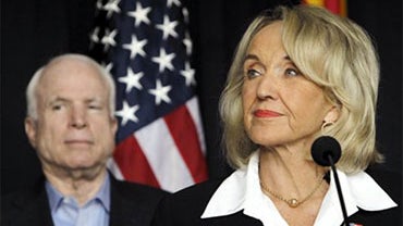 Gov. Jan Brewer, right, pauses before answering a question regarding the latest on the new Arizona immigration law, accompanied by Sen. John McCain, in Glendale, Ariz., Friday, July 30, 2010. Brewer and McCain held the news conference in the Phoenix subur 