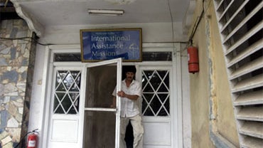 A man walks out of the office of the International Assistance Mission in Kabul, Afghanistan, Aug. 7, 2010. Ten members of International Assistance Mission medical team, including Thomas Grams, a dentist from Colorado, were shot and killed by militants. 