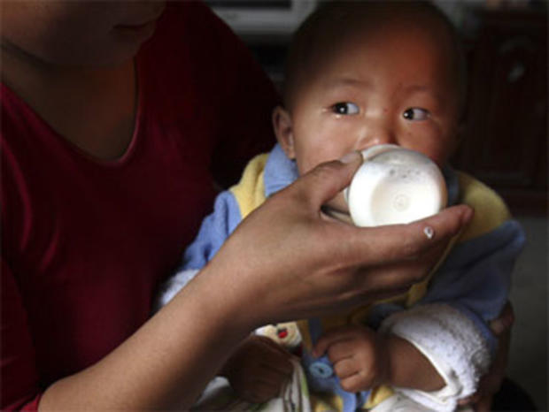 In this Oct. 15, 2008 file photo, a baby drinks milk from a bottle at home in Yongan, in eastern China's Shandong province. 