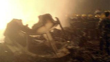 In this cell phone photo released by China's Xinhua news agency, rescuers work at the site of a reported plane crash at an airport in northeast China's Heilongjiang province on Tuesday, Aug. 24, 2010. 