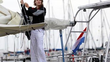 Laura Dekker hoists a flag of The Sea Shepherd Conservation Society on her boat in the harbor of Den Osse, southwest Netherlands, Aug. 4, 2010. 