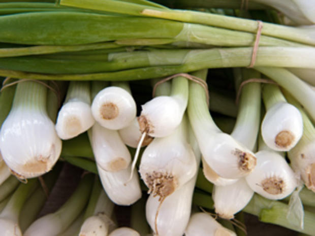 Spring onions are seen for sale at a "fa 