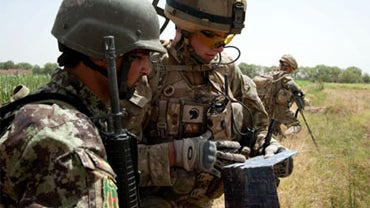 A July 2010 photo shows a British soldier as he works with an Afghan trooper, during Operation Tor Shezada (Black Prince), being carried out by a Combined Force in Sayedebad, Afghanistan.  
