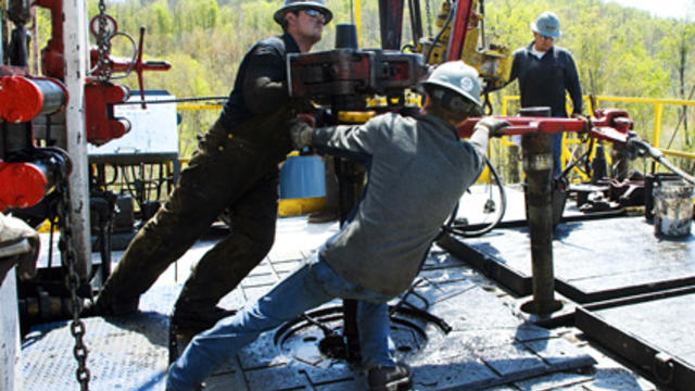 Workers move a section of well casing into place at a Chesapeake Energy natural gas well site near Burlington, Pa., in this April 2010 photo.  