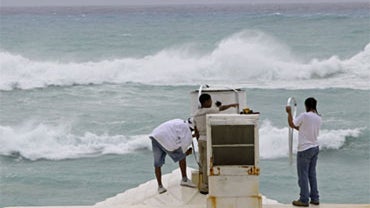 Workers at Elbow Beach secure rooftop equipment as Hurricane Igor approaches in Paget Parish, Bermuda, Saturday, Sept. 18, 2010.  
