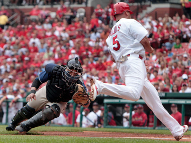 Albert Pujols is safe at home as he avoids the tag 