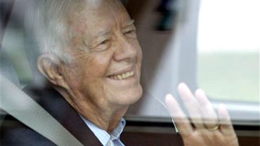 Former President Jimmy Carter waves from a vehicle as he leaves MetroHealth Hospital Thursday, Sept. 30, 2010, in Cleveland. Carter left the hospital where he spent two days recovering from a viral infection doctors say likely gave him stomach problems. ( 