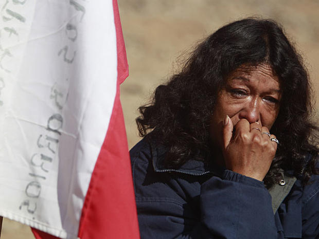 relative of a trapped miner gestures after the announcement that a drill reached the trapped miners in the San Jose mine near Copiapo, Chile, Saturday Oct. 9, 2010. Officials announced that the drill trying to reach the 33 trapped miners reached them Satu 