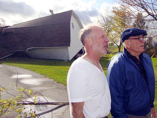 Bob Miller, left, and his father Norm inspect the damage to Norm&acirc; 