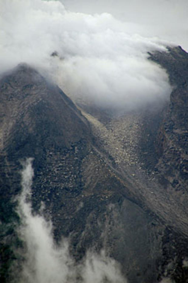 The crater of Mount Merapi is seen emitting smoke in this photograph taken from Klaten district, Central Java province on October 25, 2010. Indonesia ordered thousands of people to evacuate from around Mount Merapi as it raised the alert for its most acti 