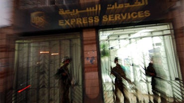 Yemeni security are seen outside a branch of the package delivery firm UPS in San'a, Yemen, October 30, 2010. 