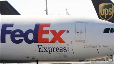In this Oct. 30 2010 file photo, FedEx and UPS cargo planes sit on the tarmac of the north cargo terminal area at Hartsfield-Jackson Atlanta International Airport in Atlanta. The glaring weakness of the cargo shipping system has been laid bare by the Yeme 