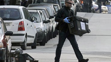 A policeman removes equipment after a controlled explosion of a package, which was addressed to the German Embassy in Athens, took place outside of courier company on November 2, 2010 in Athens.  