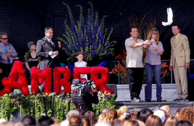 Maurice Dubois and his ex-wife, Carrie McGonigle, release a dove in honor of their daughter, Amber Dubois, during a celebration of her life ceremony at Escondido High School on March 27, 2010. 