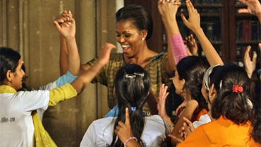 U.S. first lady Michelle Obama dances with underprivileged children at the Mumbai University in Mumbai, India, Saturday, Nov. 6, 2010. 