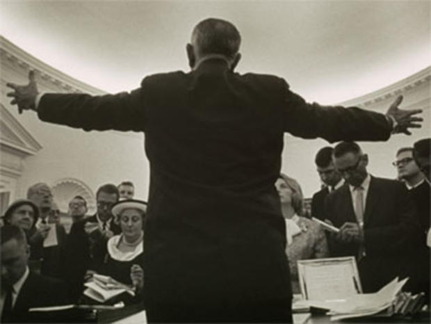 Lyndon B. Johnson's photographer Yoichi Okamoto disappeared behind the President to make this image in the Oval Office. 