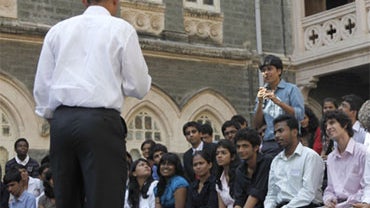US President Barack Obama, left, takes a question from a member of the audience during a town hall meeting with students at St. Xavier's College in Mumbai, India, Sunday, Nov. 7, 2010. 