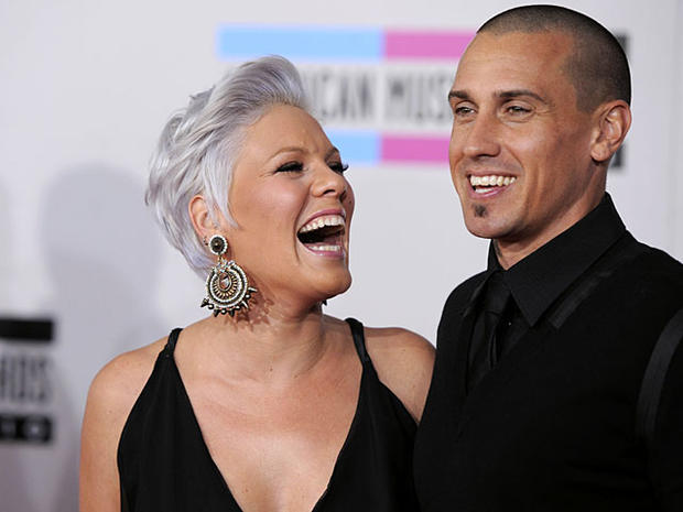 Pink, left, and Carey Hart arrive at the 38th Annual American Music Awards on Sunday, Nov. 21, 2010 in Los Angeles. (AP Photo/Chris Pizzello) 
