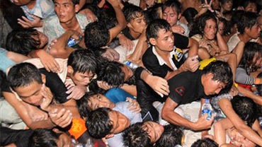 A crowd of Cambodians are pushed onto a bridge on the last day of celebrations of a water festival in Phnom Penh, Cambodia, Monday, Nov. 22, 2010. Thousands of people celebrating a water festival on a small island in a Cambodian river stampeded Monday eve 