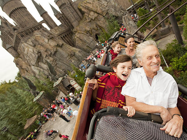 In this Saturday, Nov. 27, 2010 photo provided by Universal Orlando Resort, Academy Award-winning actors Michael Douglas, right, and wife Catherine Zeta-Jones, second from right, along with their children Dylan, 10, front left, and Carys, 7, pass over The 