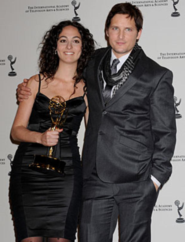 Julieta Shama poses with actor and presenter Peter Facinelli with her award for Non Scripted Entertainment at the 38th International Emmy Awards, Monday, Nov. 22, 2010, in New York. (AP Photo/Louis Lanzano) 