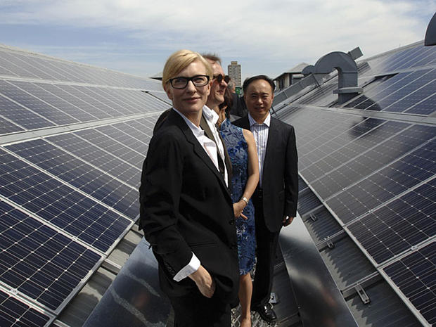 Sydney Theatre Company's artistic director and actress Cate Blanchett, front, stands on the roof amongst the new solar panels at The Wharf Theatre in Sydney, Friday, Nov. 26, 2010. Comprised of 1906 solar panels , enough to power 46 average homes, it is A 