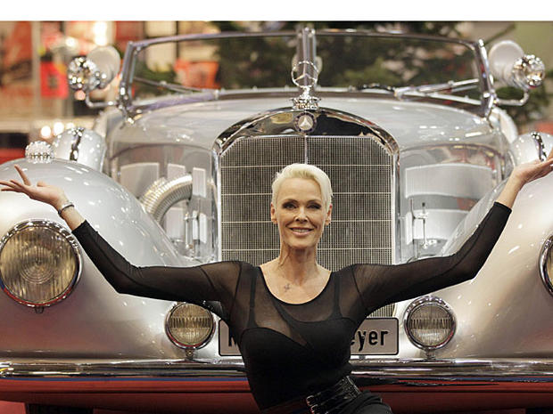 Danish actress Brigitte Nielsen poses in front of a 500 Mercedes Benz car, which was built in 1935, in Essen, Germany, Friday Nov. 26, 2010. The 500 Mercedes with an 8 cylinder OHV inline engine and a switchable Roots compressor was custom made for the fo 