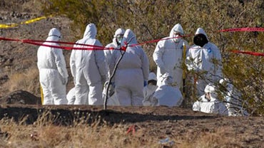 Forensic experts work at the site where at least 18 bodies were found near a ranch in the town of Palomas, near the northern border city of Ciudad Juarez, Mexico Monday Nov. 29, 2010 
