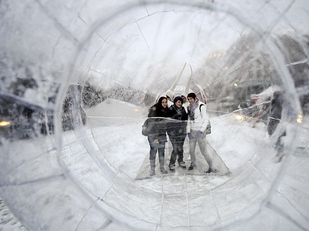 Students pose for a photograph as they stand inside a giant 25-meter long condom during an AIDS awareness event marking World AIDS Day in Budapest on December 1, 2010. AFP PHOTO / ATTILA KISBENEDEK (Photo credit should read ATTILA KISBENEDEK/AFP/Getty Ima 
